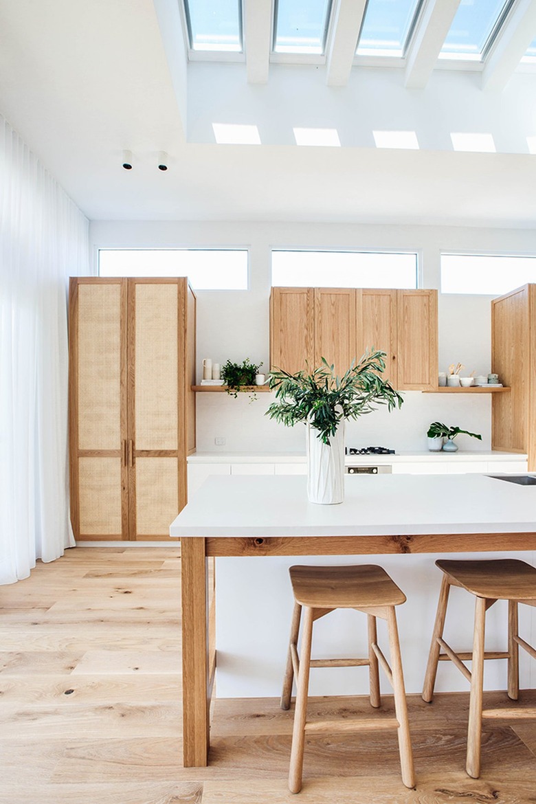 greenery in vase on white and wood kitchen island