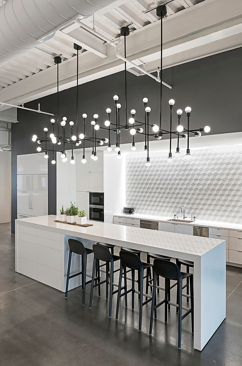 white modern kitchen with bold chandelier over island