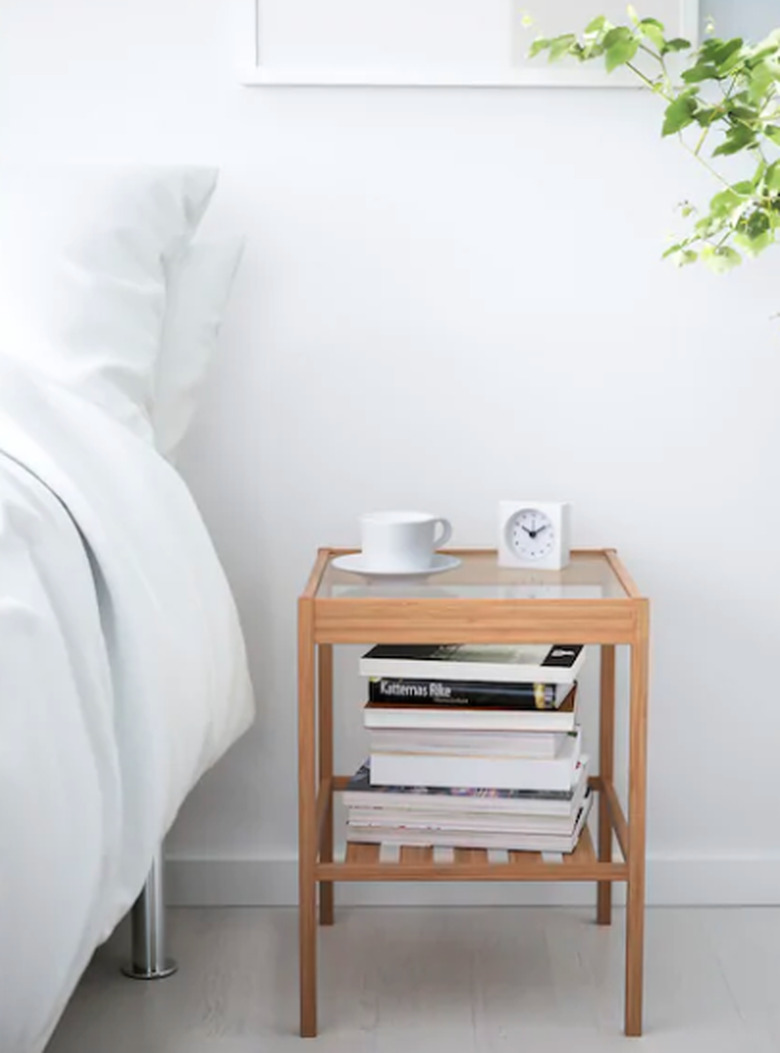 bedside table near bed and plants