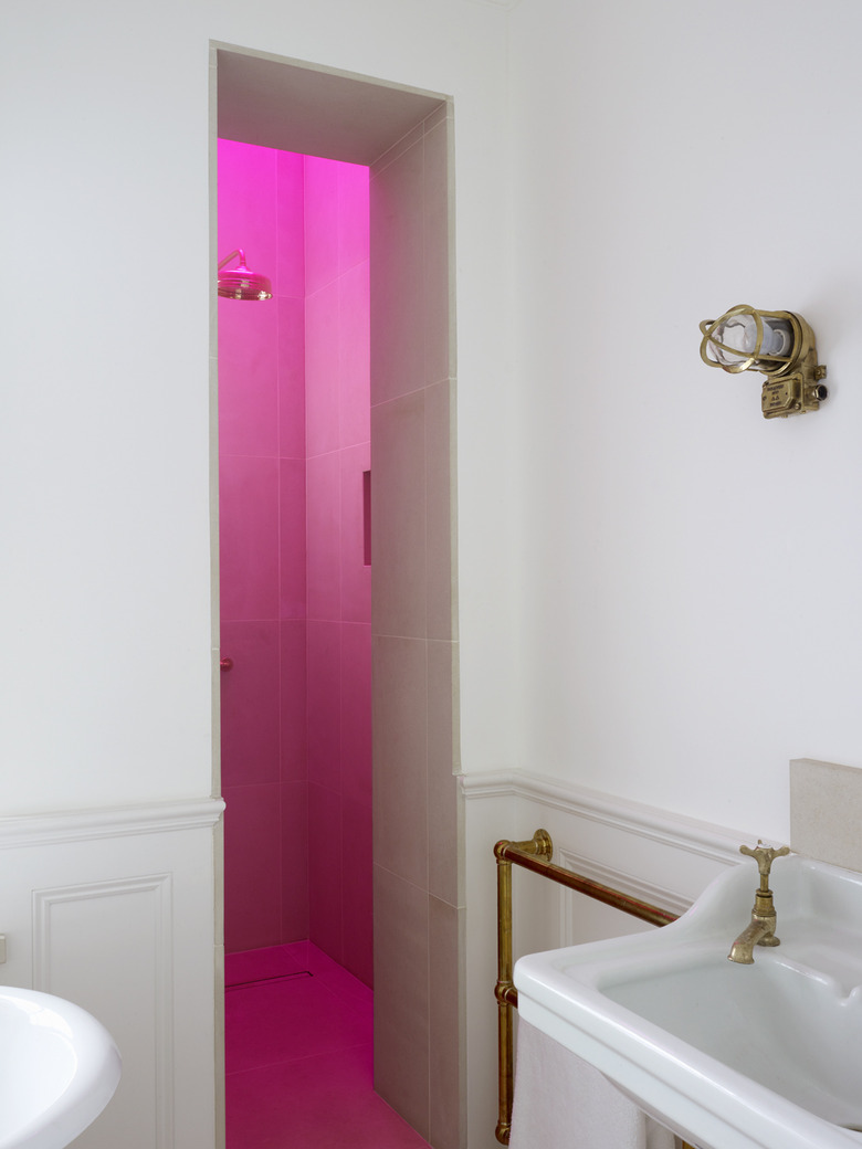 neon hot pink skylight in shower and vintage brass details in Harriet Anstruther's bathroom