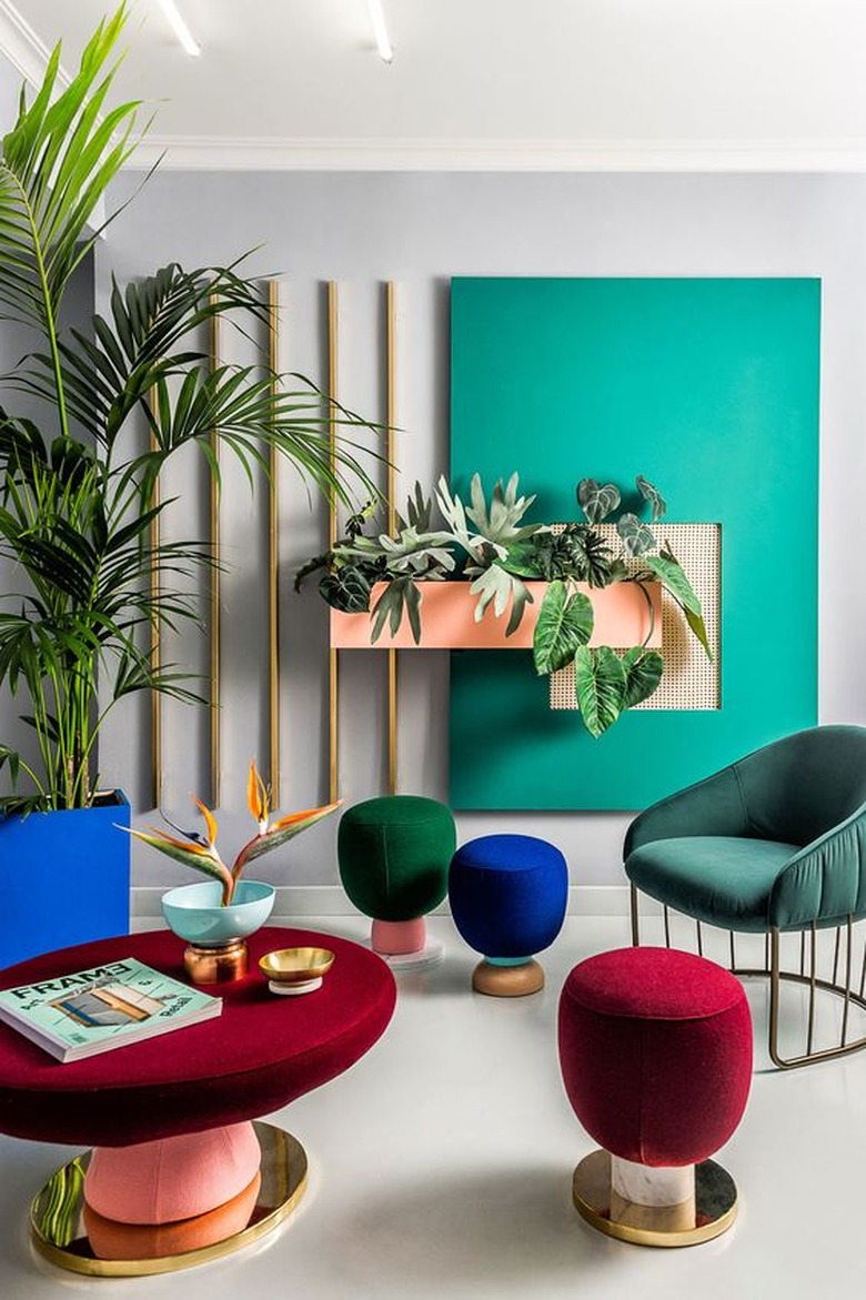 seating area with jewel-tone upholstered chairs, poufs, and tables