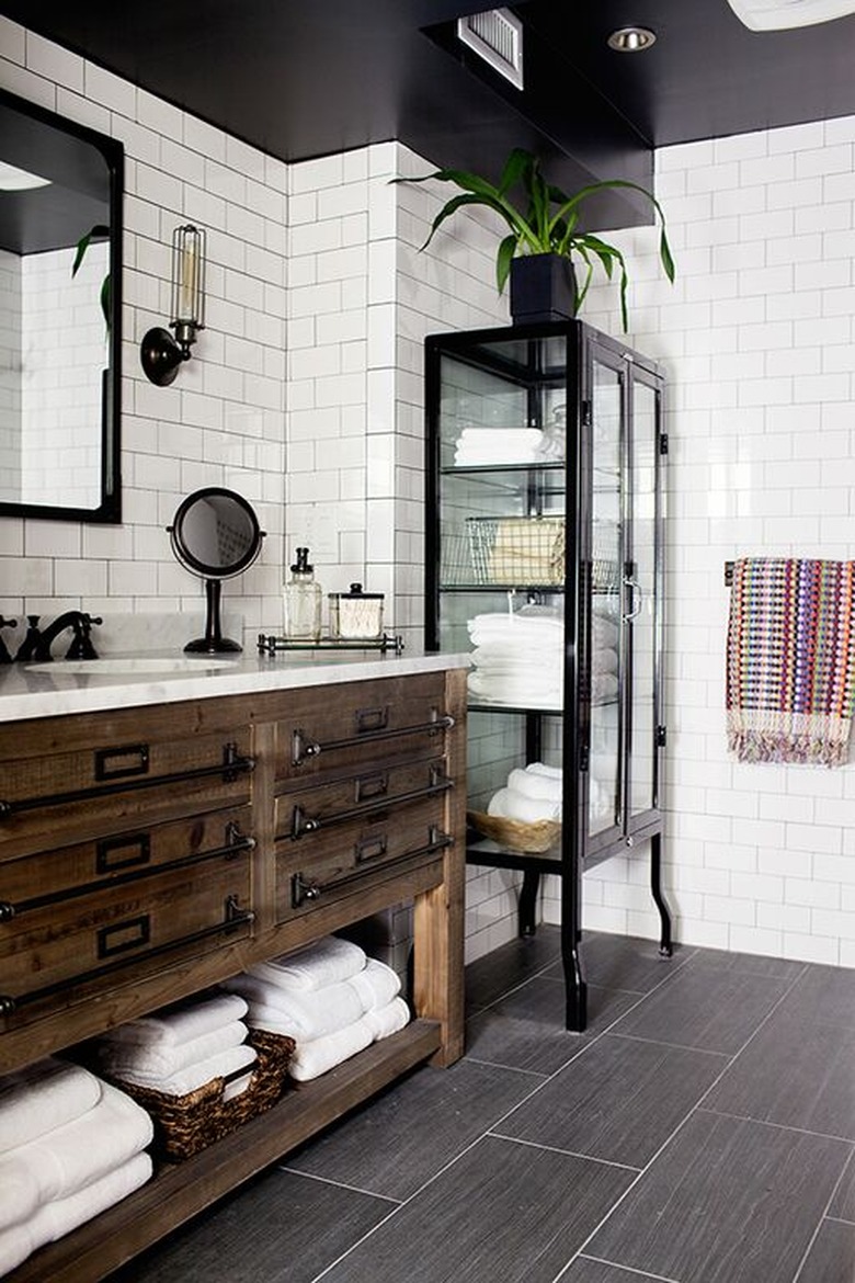 industrial bathroom with white subway tile and rustic vanity