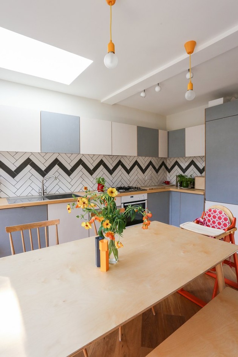 chevron tile backsplash in a fun, colorful London kitchen