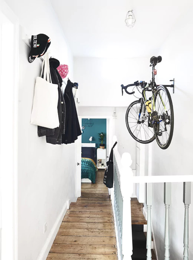 hanging bike rack in hallway with wall hooks