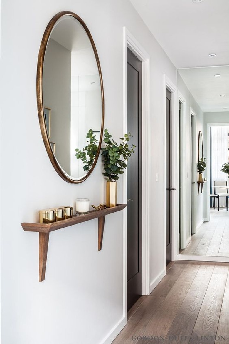 Circular mirror in hallway