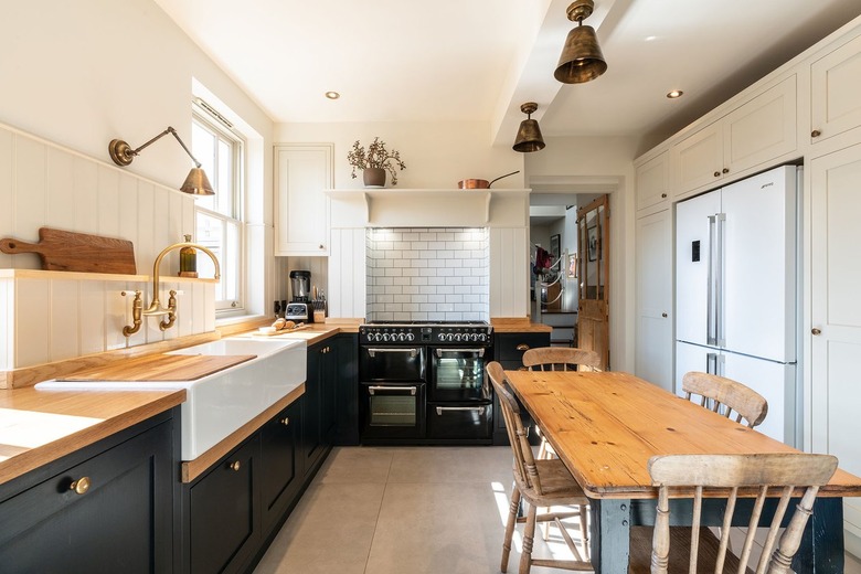 black and wood l-shaped kitchen with dining table