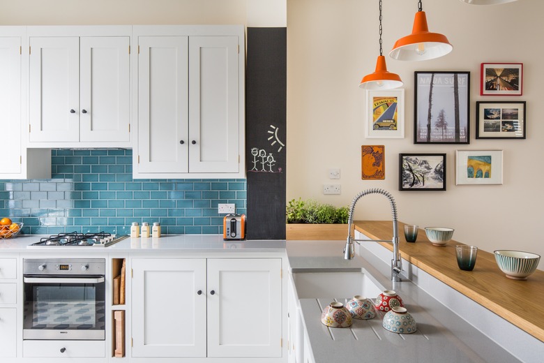 L-shaped kitchen with white cabinets and tile backsplash