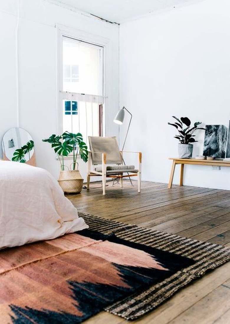 Layered rugs in mid-century bedroom