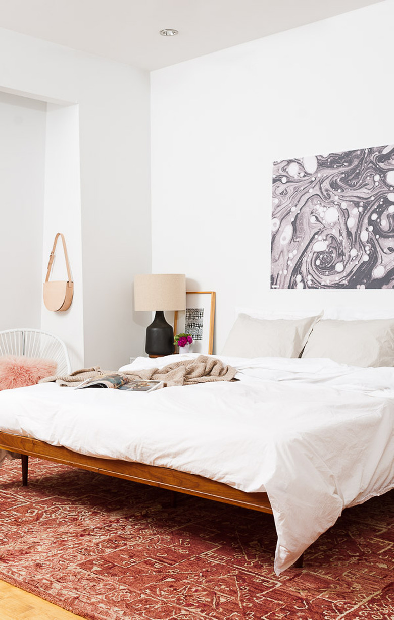 Midcentury bedroom with long-legged bedframe and empty space underneath the bed