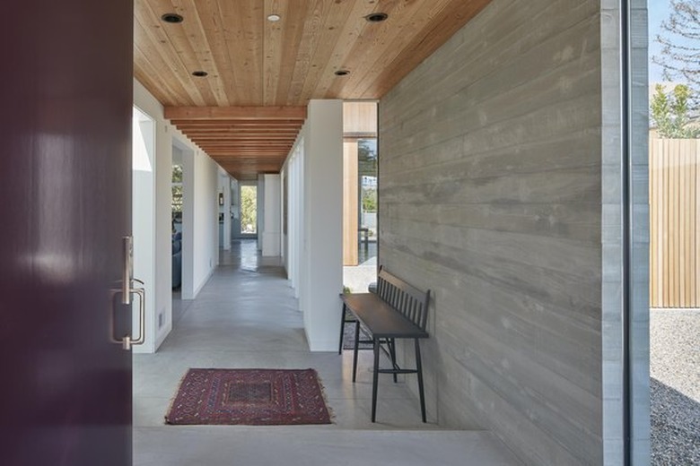 front door and entryway of minimal modern home with cement floors