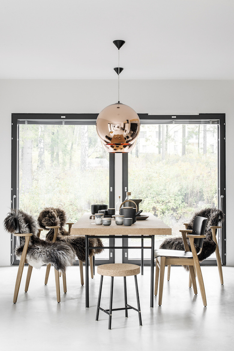 Scandinavian dining room with sheepskin rugs on seats