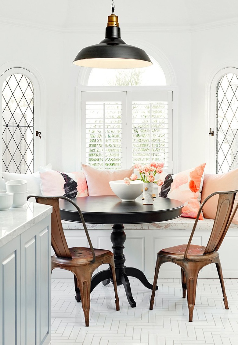 small dining room with black table and copper chairs and built-in bench