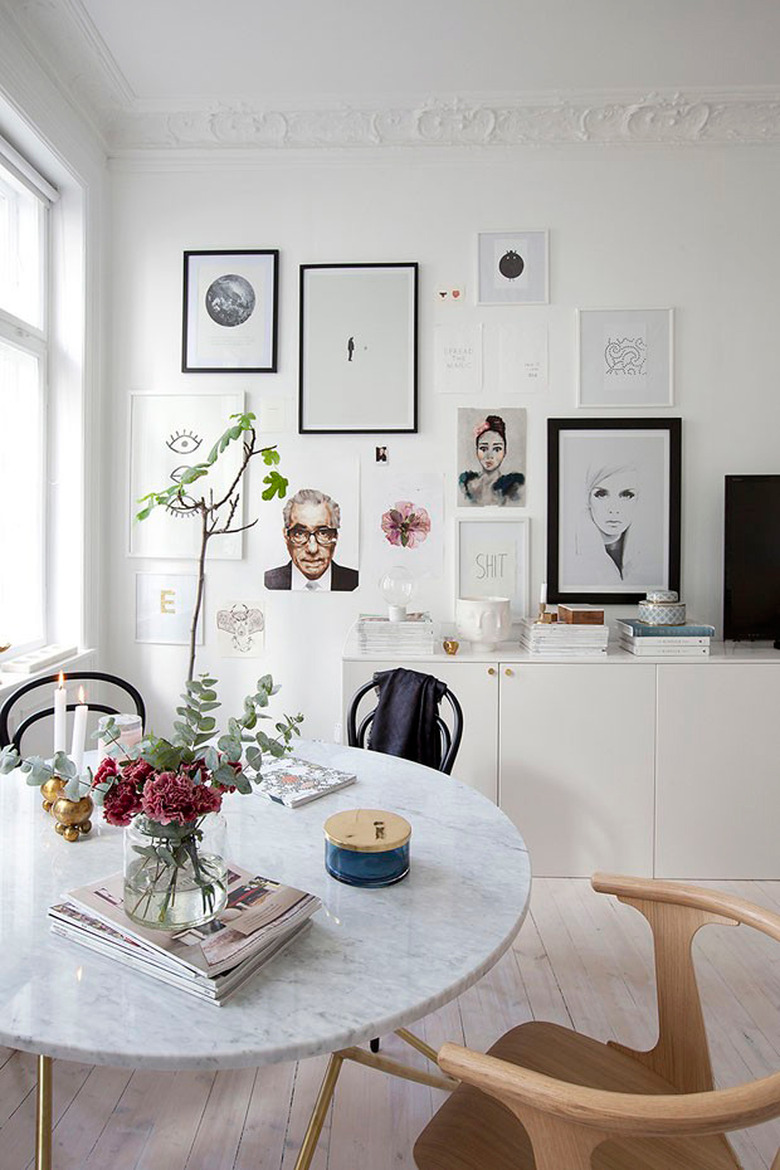 small dining room with mismatched chairs and marble top dining table