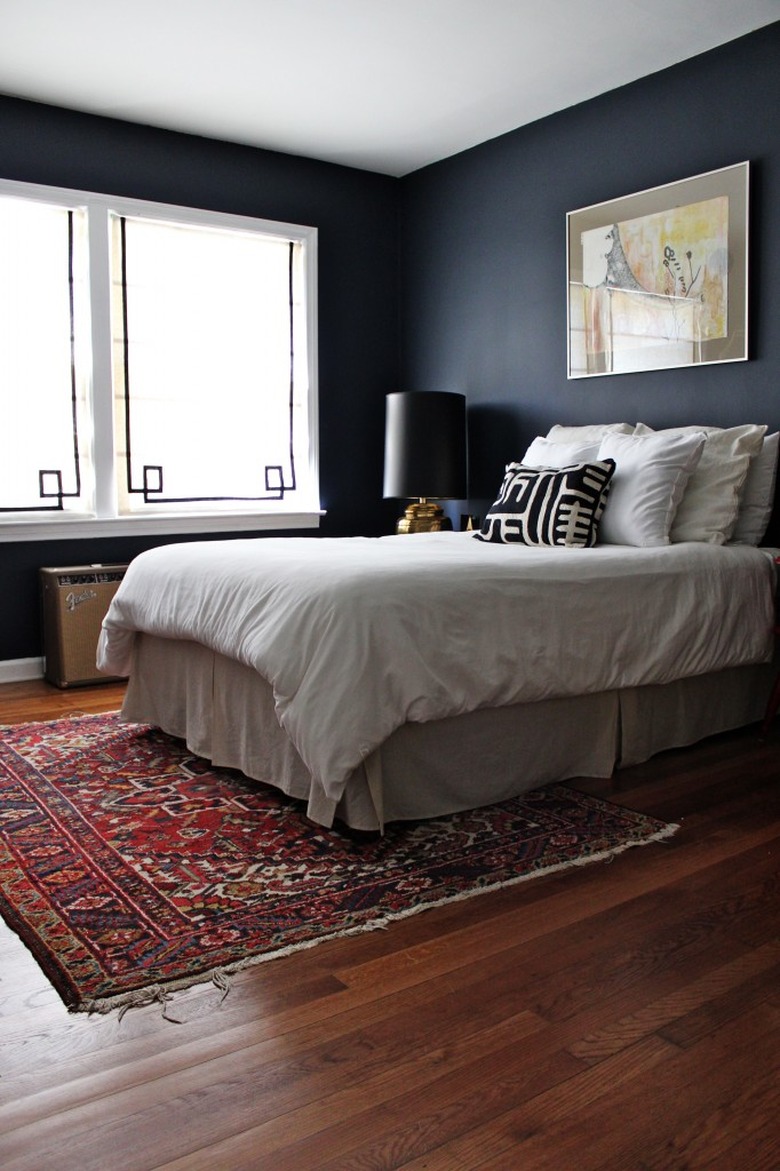 matte navy blue bedroom walls with oriental area rug