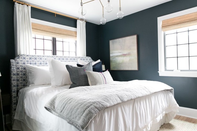 blue-green bedroom with brass chandelier