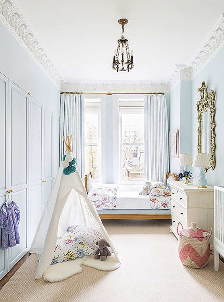 light blue nursery with white crib