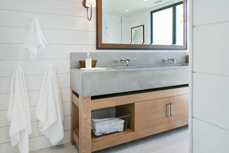 Concrete trough sink in rustic bathroom with shiplap walls