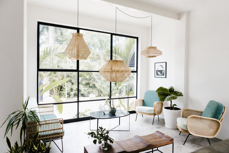 Wicker pendant lights, accent chairs, bench, plants