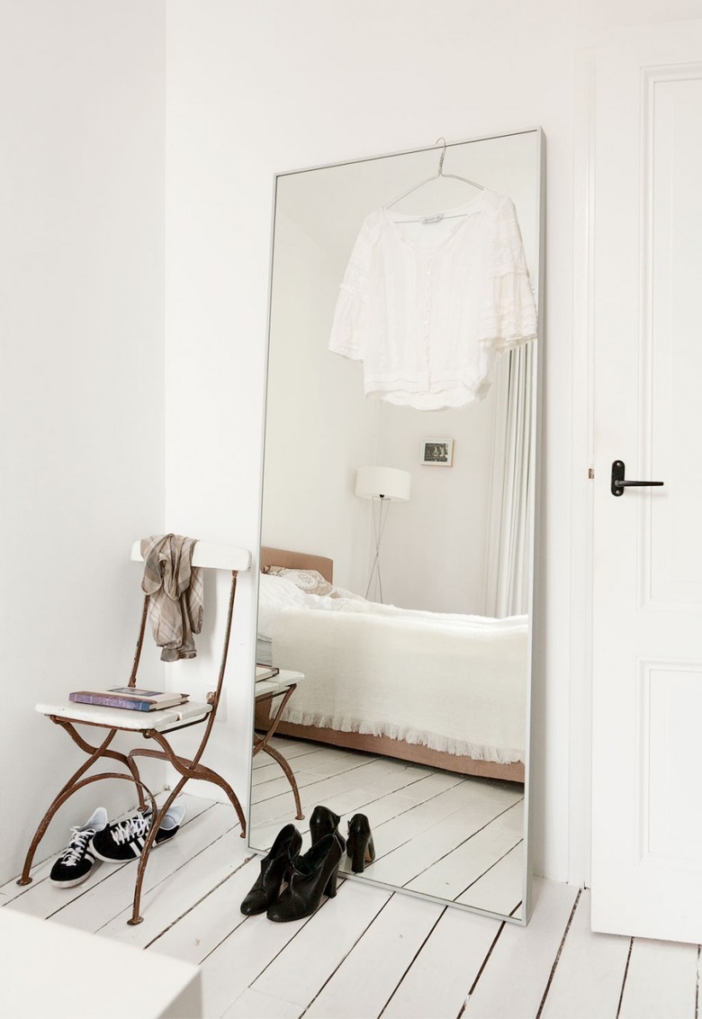 leaning floor mirror in minimalist room