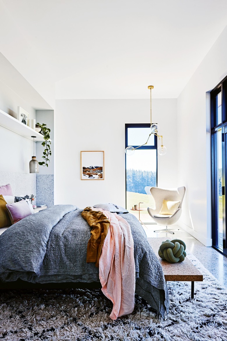 Bedroom with curved Arne Jacobsen Egg Chair