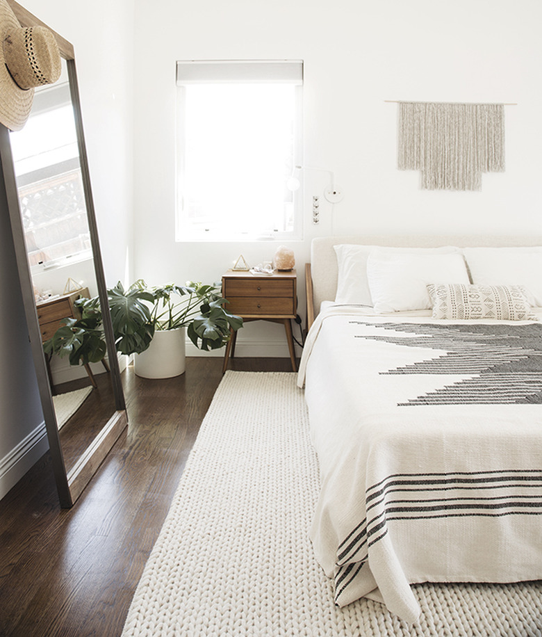 Minimal white bedroom with gray and white textile bedding