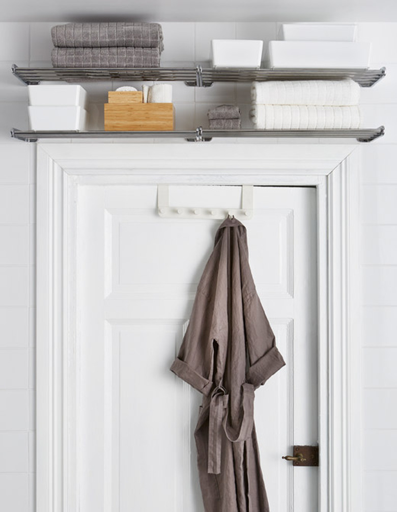 metal rack mounted above bathroom door.