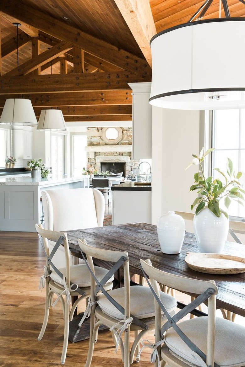 rustic dining room with drum pendant and wood table