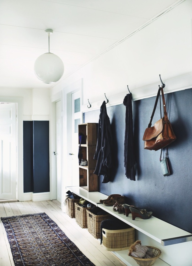 A mudroom with dark blue walls