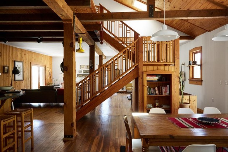 midcentury cabin dining room with open beamed ceiling and rustic wood accents