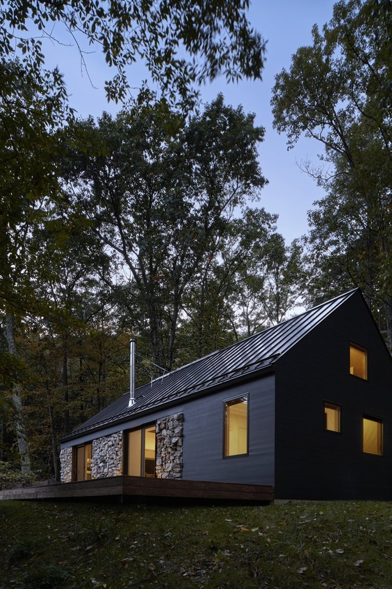 modern barn-like cabin with black metal roof and matte black siding