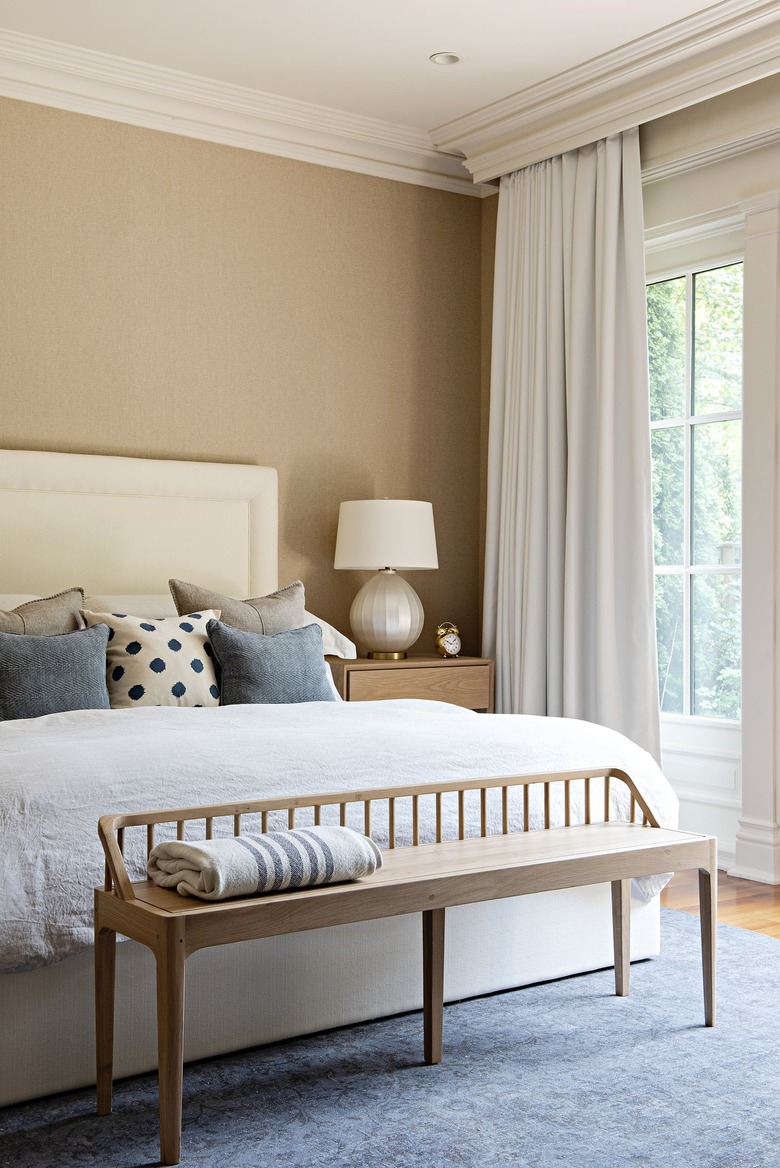 small bedroom with floor to ceiling window treatments