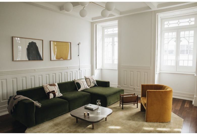 minimalist living room with green sofa and mustard lounge chair