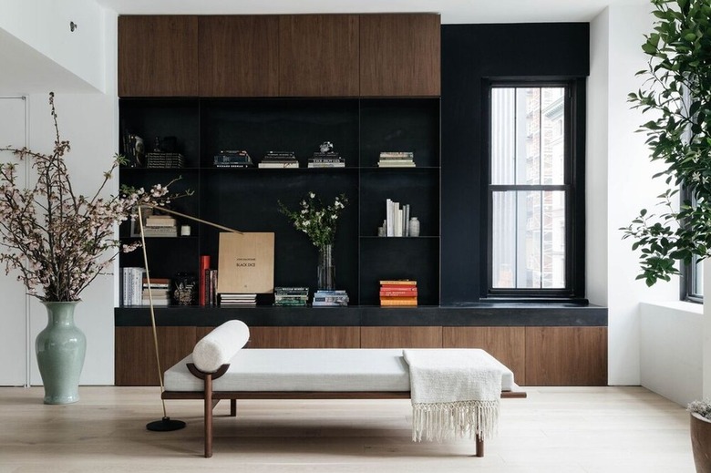 minimalist living room with daybed and accessories displayed on shelving unit