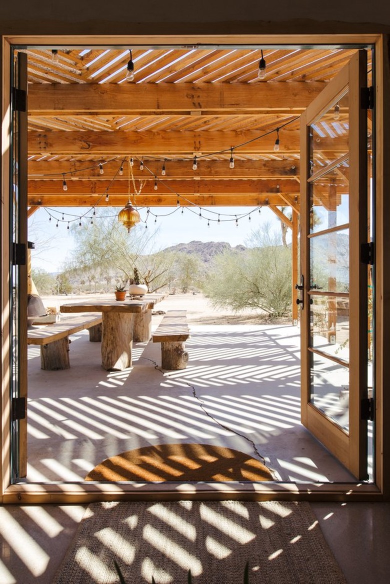 patio dining area with pergola and French doors