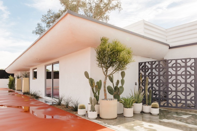 midcentury palm springs tennis club exterior with potted cactuses