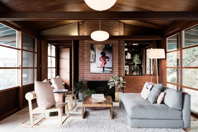 midcentury living room with dark wood accents and light-toned furniture