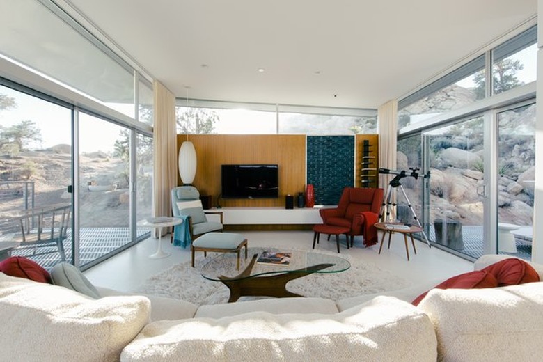 midcentury-style living room with large windows and a noguchi-style coffee table