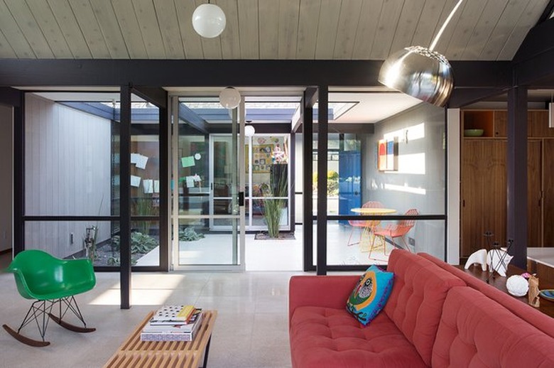 midcentury living room and breezeway with classic, colorful furnishings