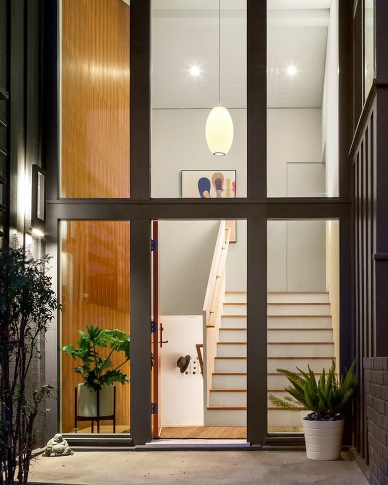 midcentury entryway with cigar pendant lamp