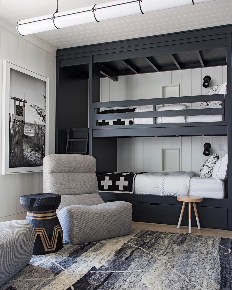 bedroom with shiplap walls and black built in bunk beds