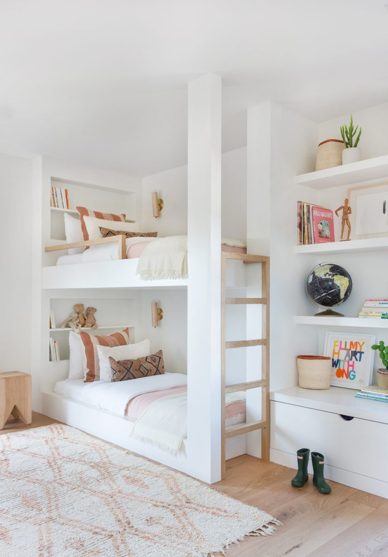 white bedroom with bunk beds accented with pastel hues