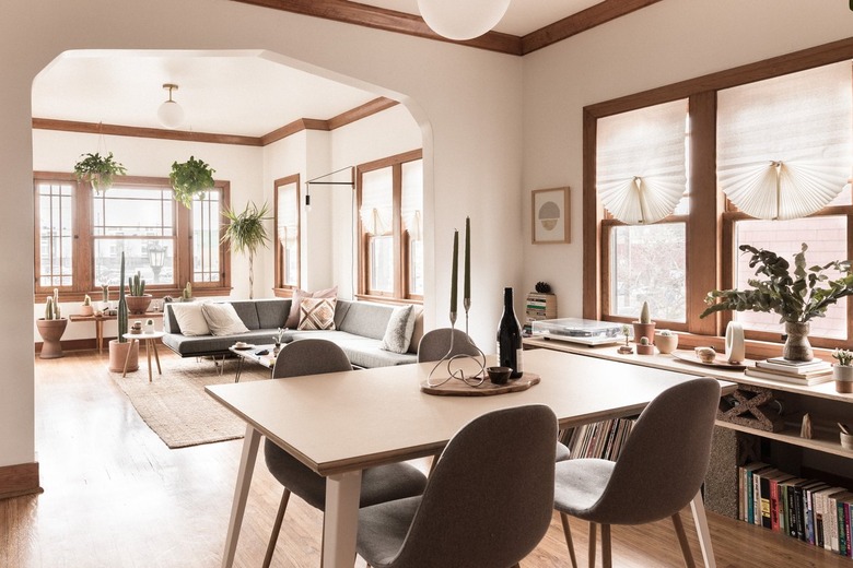 minimalist dining room with wood table, pendant lamp and grey Eames chairs