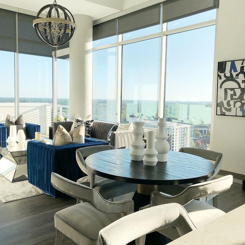 justin q. williams penthouse dining room and living room featuring whites, blues, and greys