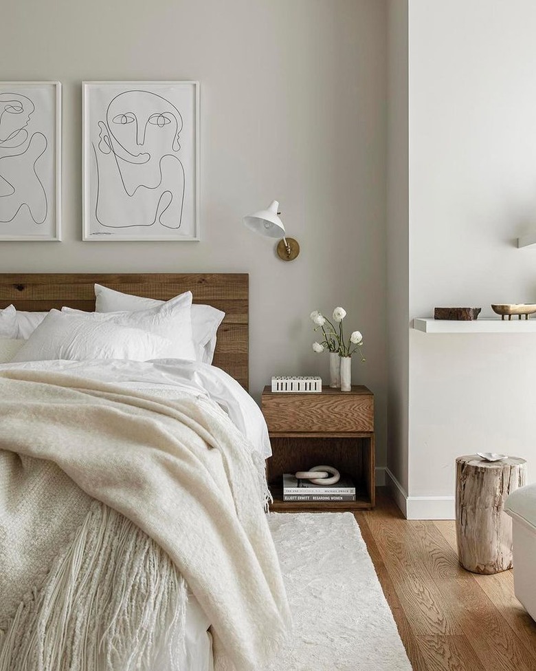 olivia stutz bedroom with white bedding and figure art