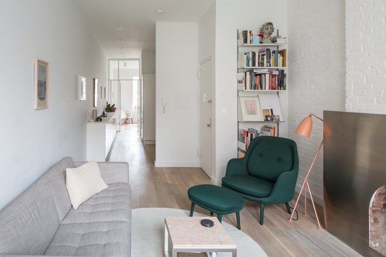 railroad style apartment with stainless steel fireplace surround