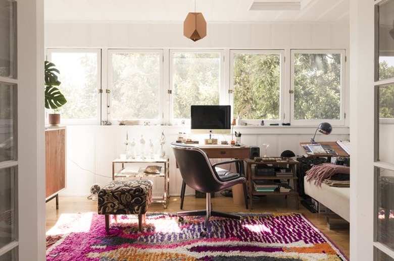 global patterns and bold colors in a tree-lined apartment living room