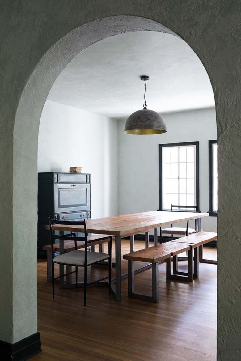 arched doorway leading to a moody dining room