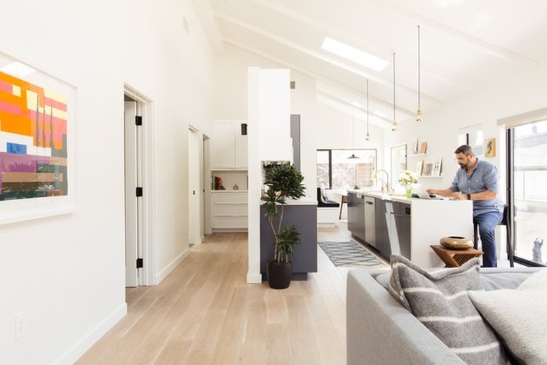 sleek modern farmhouse kitchen living room interior with skylight