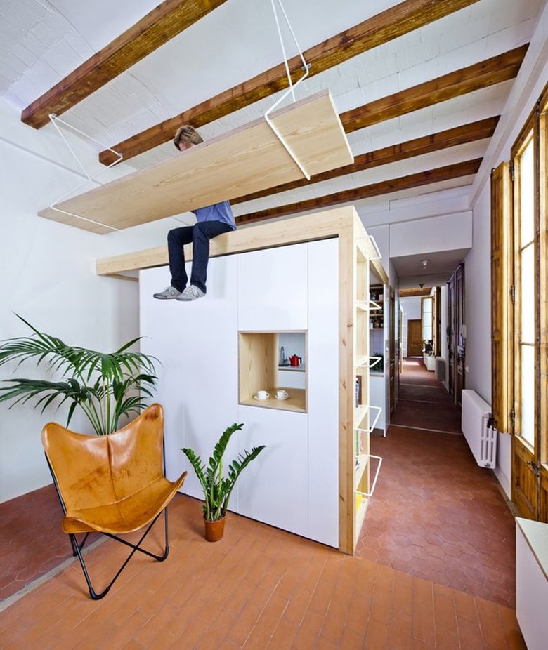 floating desk suspended above living area and kitchen