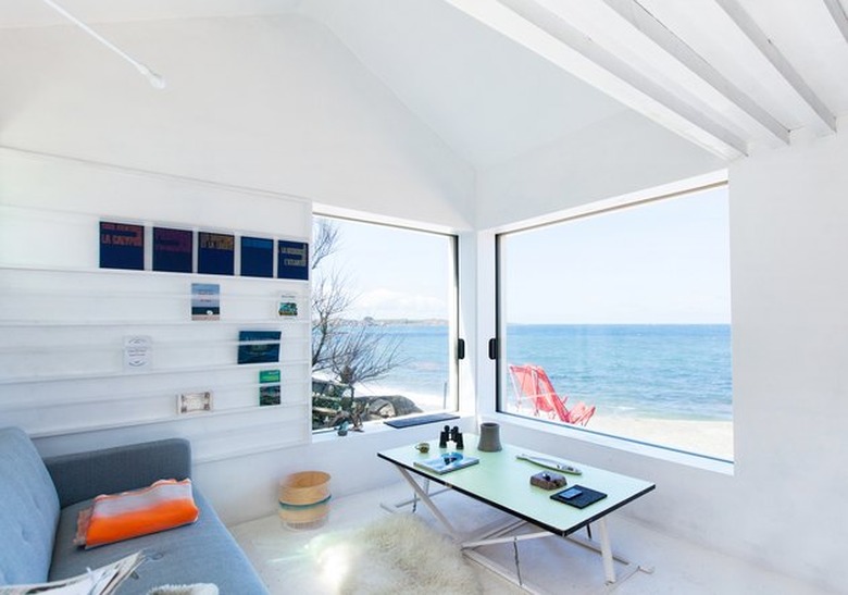 beachside cabin with ocean views from all-white living room